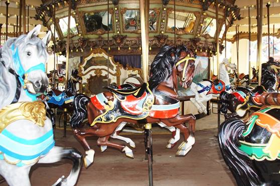 A carousel with horses on it

Description automatically generated