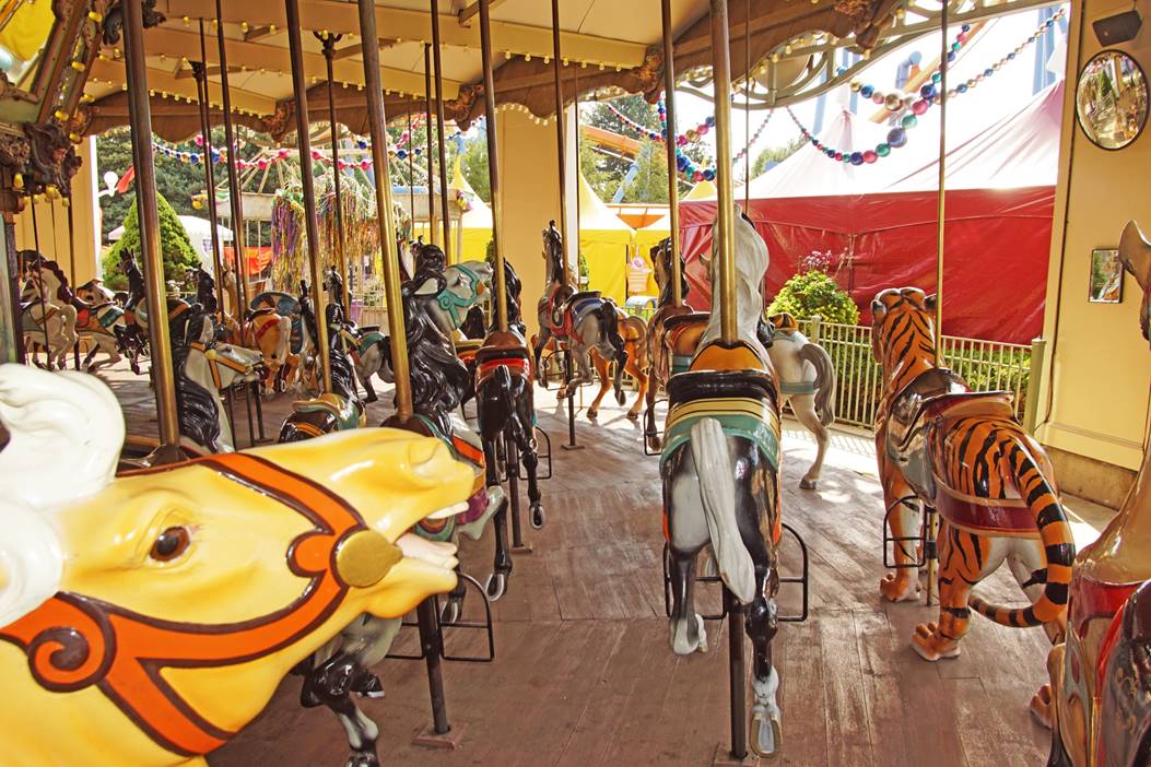 A carousel with horses and horses

Description automatically generated