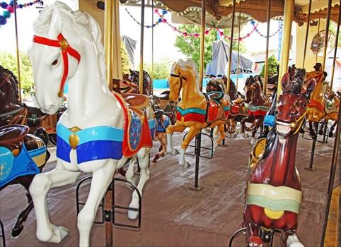 A group of horses on a merry go round

Description automatically generated