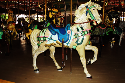 A person standing in front of a carousel

Description automatically generated