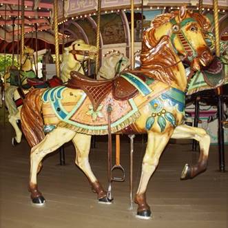 A person riding a horse in a carousel

Description automatically generated