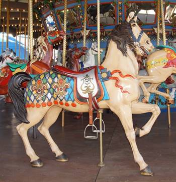 A person riding a horse in a carousel

Description generated with very high confidence