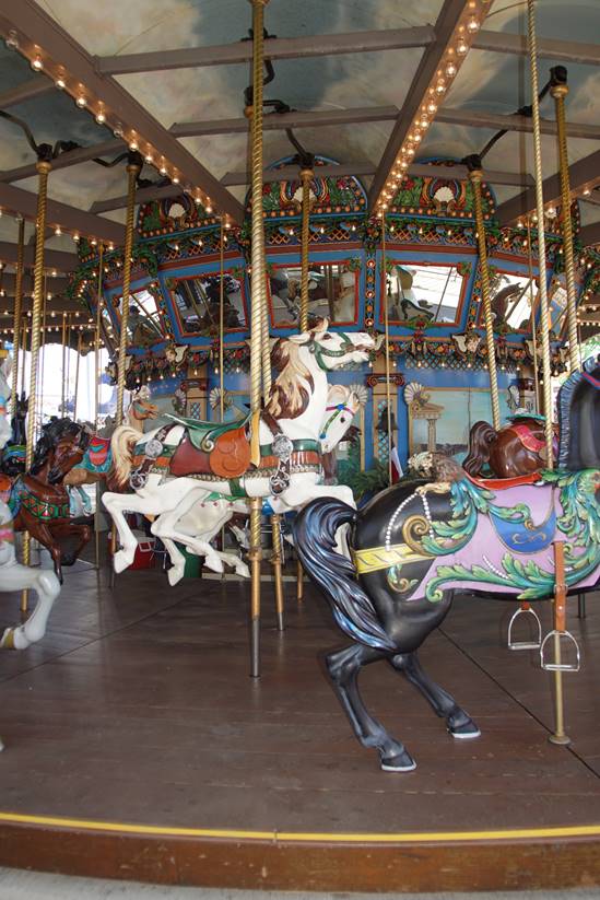 A group of people in a carousel

Description generated with high confidence