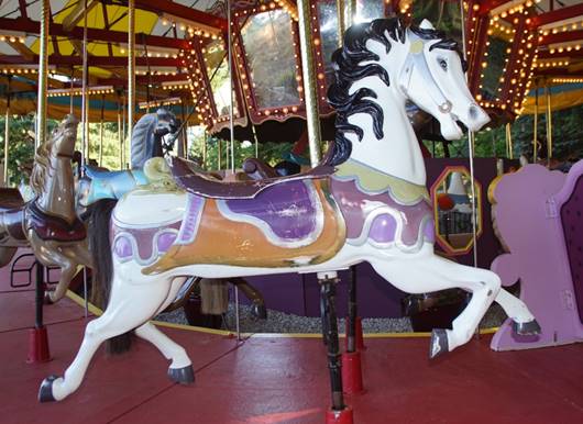 A picture containing carousel, ride, outdoor object, table

Description automatically generated