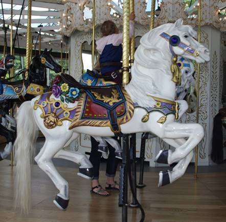 A picture containing floor, carousel, indoor, ride

Description automatically generated