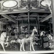 A group of people in a carousel
Description automatically generated