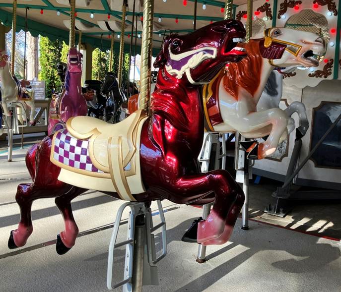 A carousel with horses on it

AI-generated content may be incorrect.