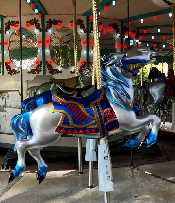 A carousel with horses and a horse on it

AI-generated content may be incorrect.