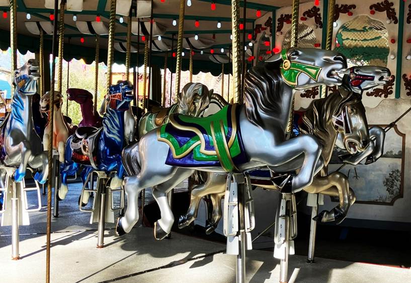 A group of horses on a merry go round

AI-generated content may be incorrect.