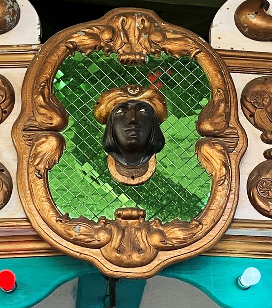 A black face in a gold frame

AI-generated content may be incorrect.