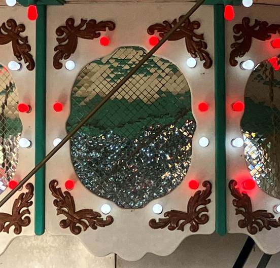 A carousel with lights and a stick

AI-generated content may be incorrect.