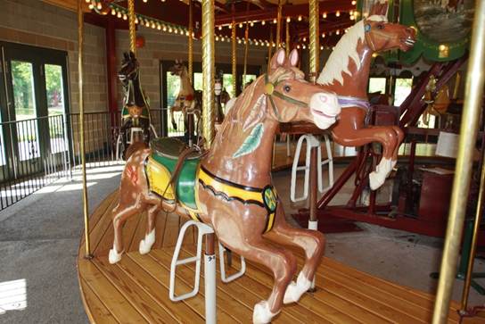 A chair sitting in front of a carousel

Description automatically generated