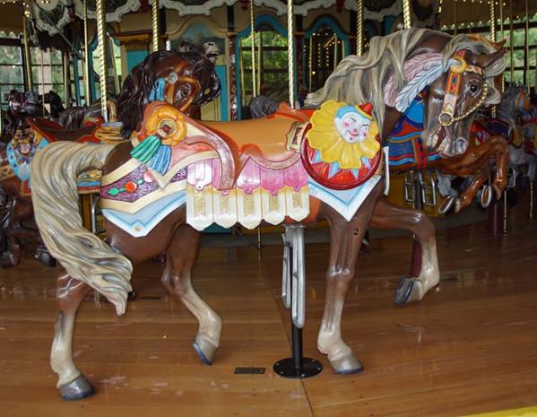 A person standing in front of a carousel

Description automatically generated